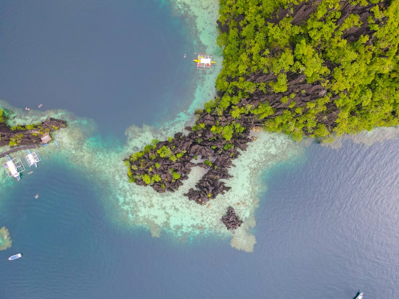 Aerial view of lush green islands and clear turquoise water.